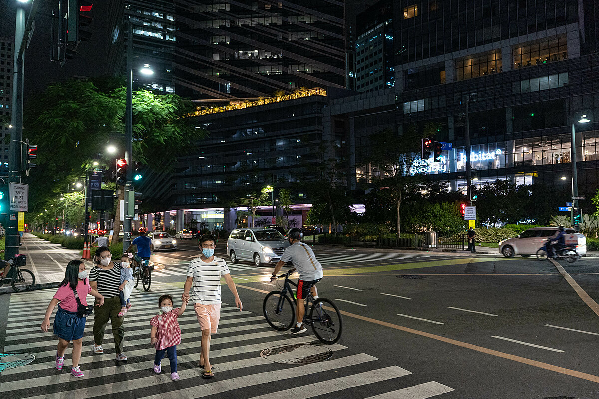Pedestrians and bikers are crossing the streets of Bonifacio Global City in Taguig, Metro Manila. 