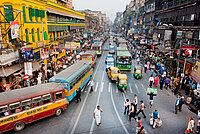 Traffic jam with hundreds of city taxi, buses and pedestrians of busy city road in Kolkata, India 
