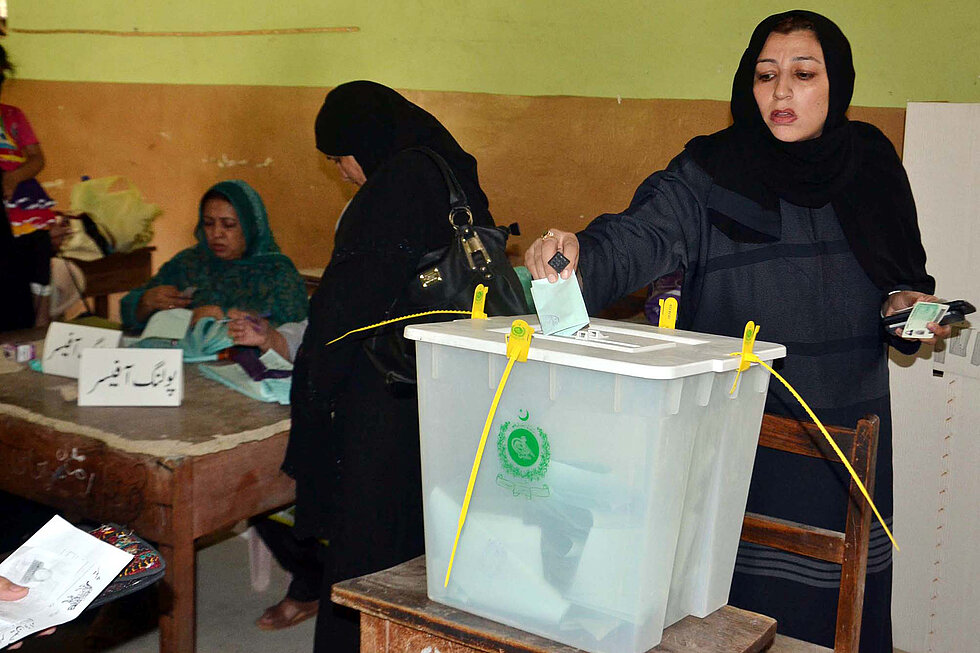 Voters cast their votes at a polling station during election.