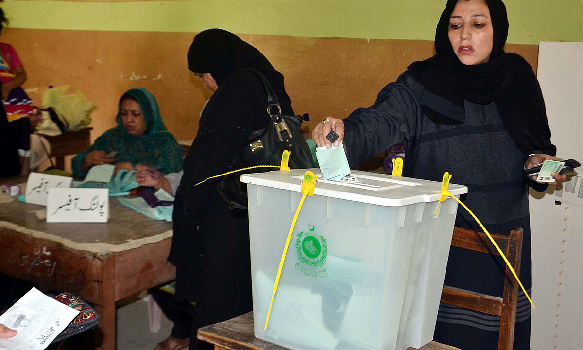 Voters cast their votes at a polling station during election.