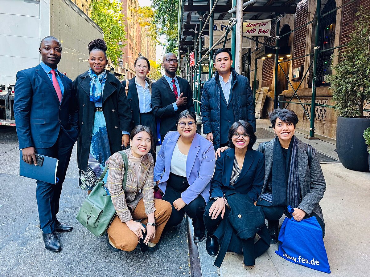 A group photo of Asian people on the street.