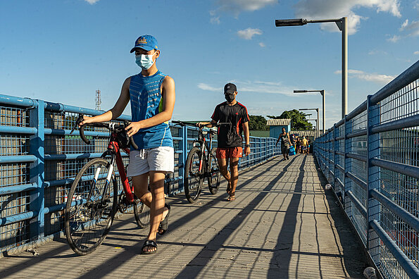 Bike commuters are using the overpass in Quezon City, Philippines.