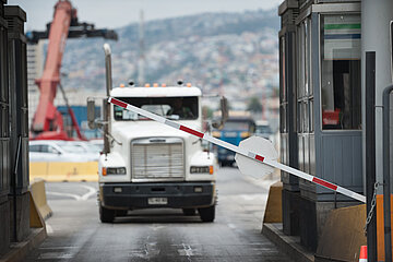 Truck in industrial port area being let through customs