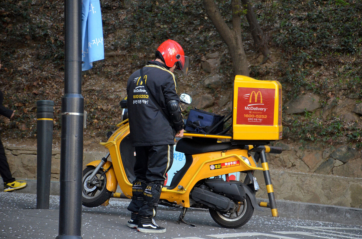 a delivery man in Soul parks his ride by the street in Seoul.