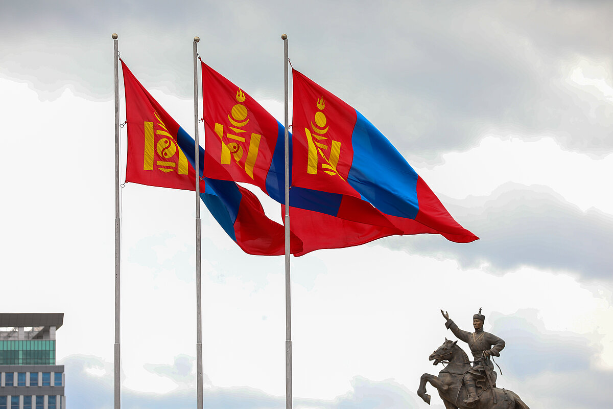 3 Mongolian flags waving in front of the State Palace of Mongolia
