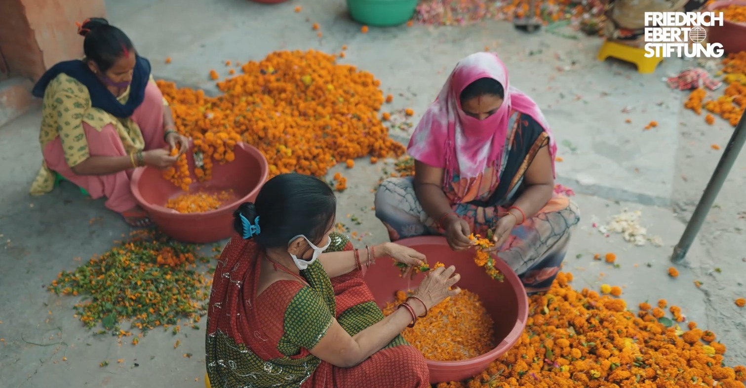 A group of Indian women collecting waste flowers