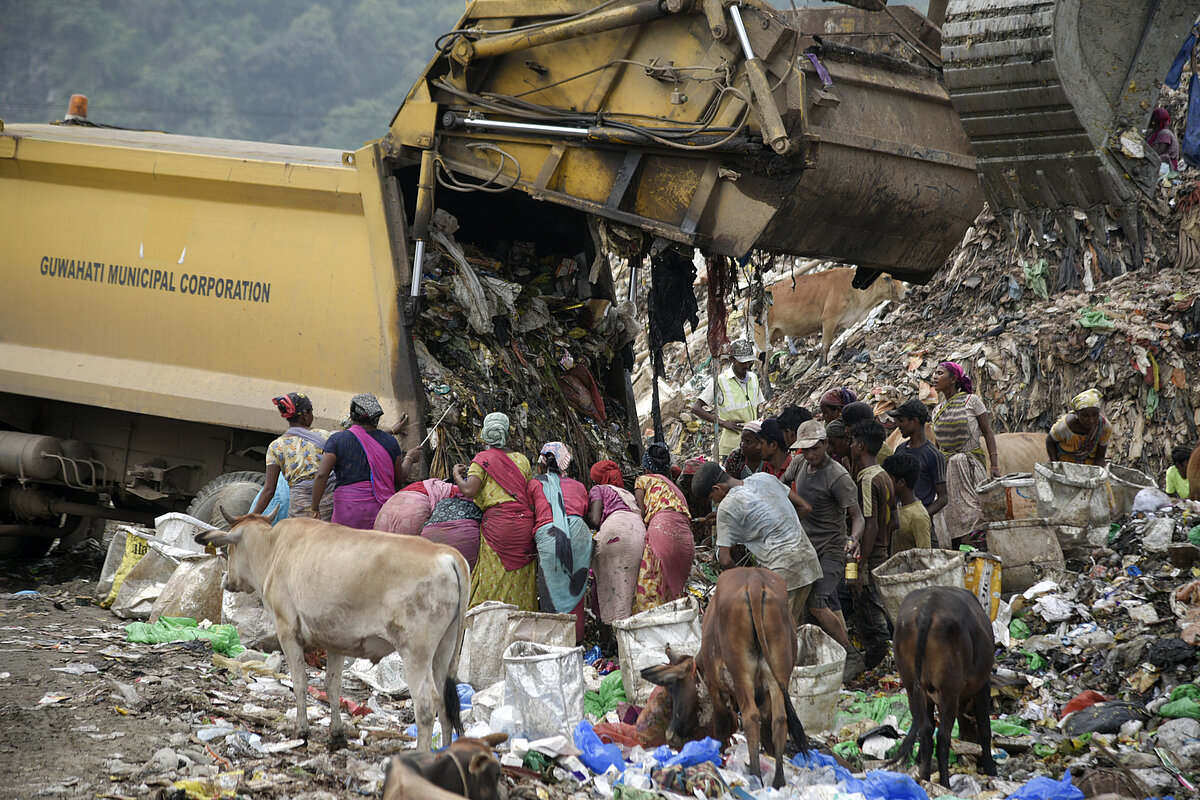 Waste pickers search for recyclable materials at a garbage dumpsite in Guwahati, India.